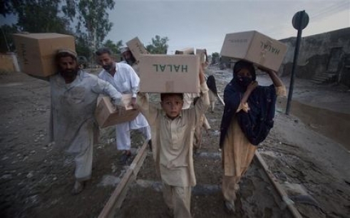  _718_https://www.helpage.org/silo/images/a-family-carries-relief-supplies-distributed-by-the-army-on-train-tracks-back-to-their-homes_491x306.jpg