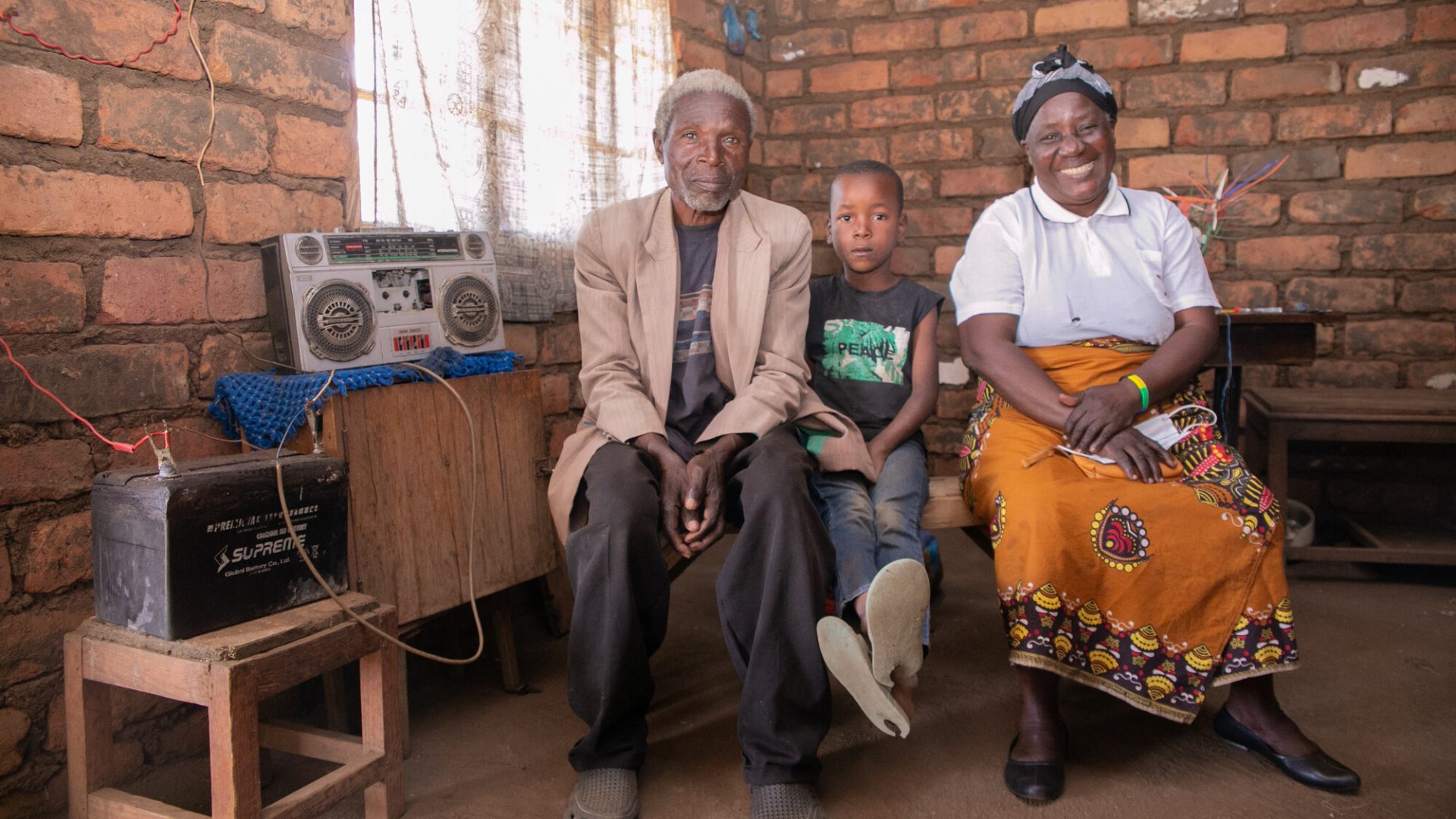 The story of Petros Yakobe Apparel, Clothing, Human, Person, Sitting, Wood The story of Petros Yakobe.He lives with his wife and 2 grandchildren...He belongs to Tiyanjane Club (Older Persons Association). ..The awareness of elderly people’s right by MANEPO from 2017 helped people like Petros Yakobe to benefit from projects taking place in their community through his participation. ..Before 2017 elderly people were never chosen or given any chance in any development activities. But after the awareness, the chief starting choosing elderly people first before the youth for any income generating activity. ..Mr Yakobe was involved in construction of drainage and at the end he was paid some money with which he bought solar panels for electrification of his house. ..This solar panel has made it possible for the family to charge their phones and also listen to the radio daily. ..“I am happy that as elderly people we are now being recognized in our communities and if it wasn’t for MANEPO to educate us on these rights I wouldn’t have been able to buy solar panels.”