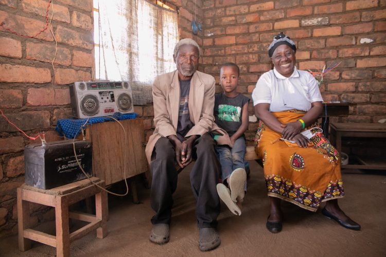 The story of Petros Yakobe Apparel, Clothing, Human, Person, Sitting, Wood The story of Petros Yakobe.He lives with his wife and 2 grandchildren...He belongs to Tiyanjane Club (Older Persons Association). ..The awareness of elderly people’s right by MANEPO from 2017 helped people like Petros Yakobe to benefit from projects taking place in their community through his participation. ..Before 2017 elderly people were never chosen or given any chance in any development activities. But after the awareness, the chief starting choosing elderly people first before the youth for any income generating activity. ..Mr Yakobe was involved in construction of drainage and at the end he was paid some money with which he bought solar panels for electrification of his house. ..This solar panel has made it possible for the family to charge their phones and also listen to the radio daily. ..“I am happy that as elderly people we are now being recognized in our communities and if it wasn’t for MANEPO to educate us on these rights I wouldn’t have been able to buy solar panels.”