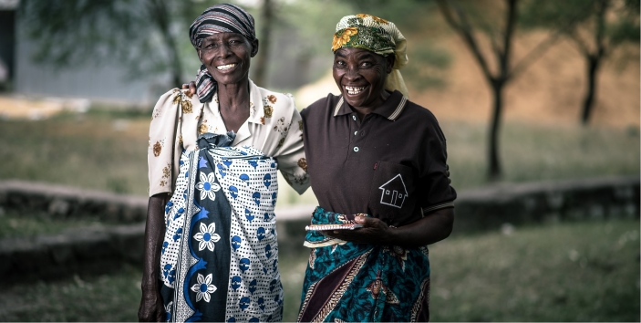  _757_https://www.helpage.org/silo/images/mwajuma-and-tereza-who-is-holding-her-memory-book-at-a-village-meeting-in-the-magu-district_703x354.jpg