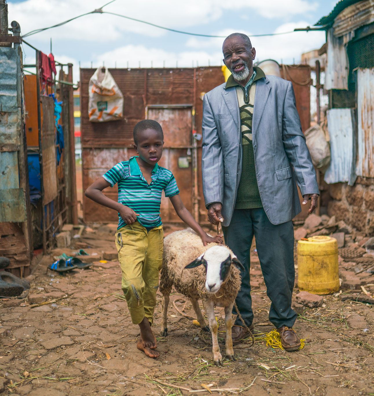 George poses with his son and one of his sheep