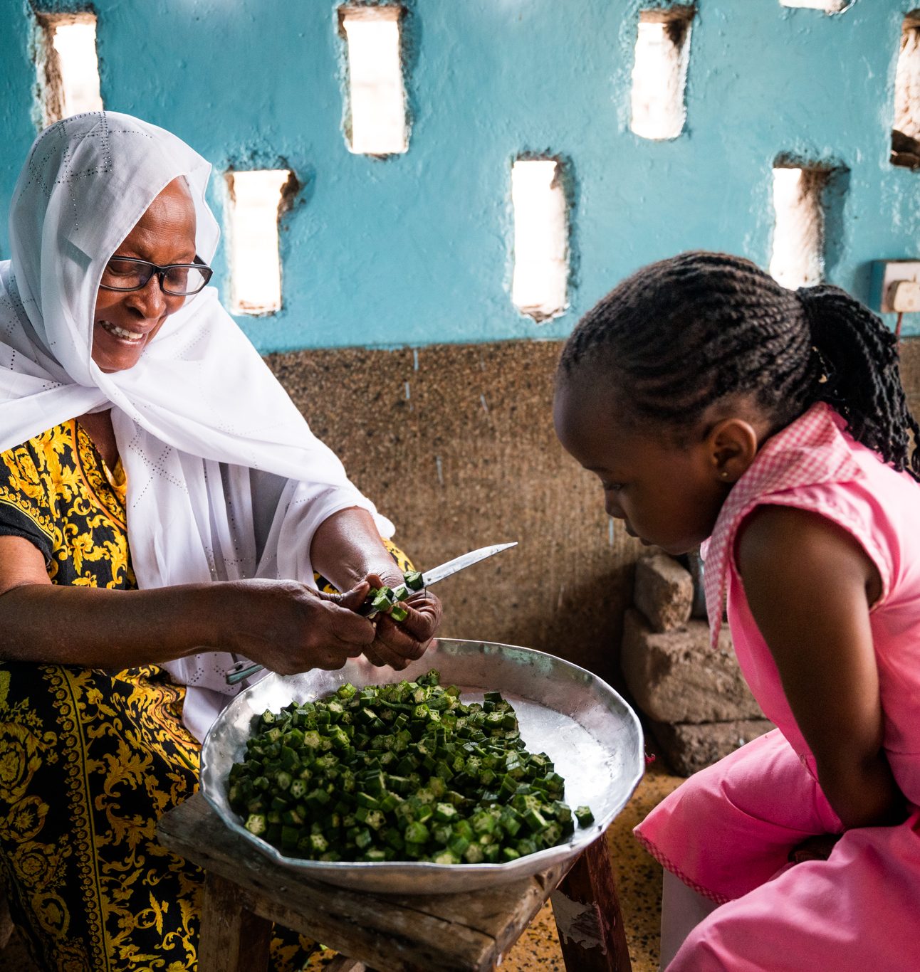 Zainab showing her grandchild how to make vegitable ready for cooking (1)