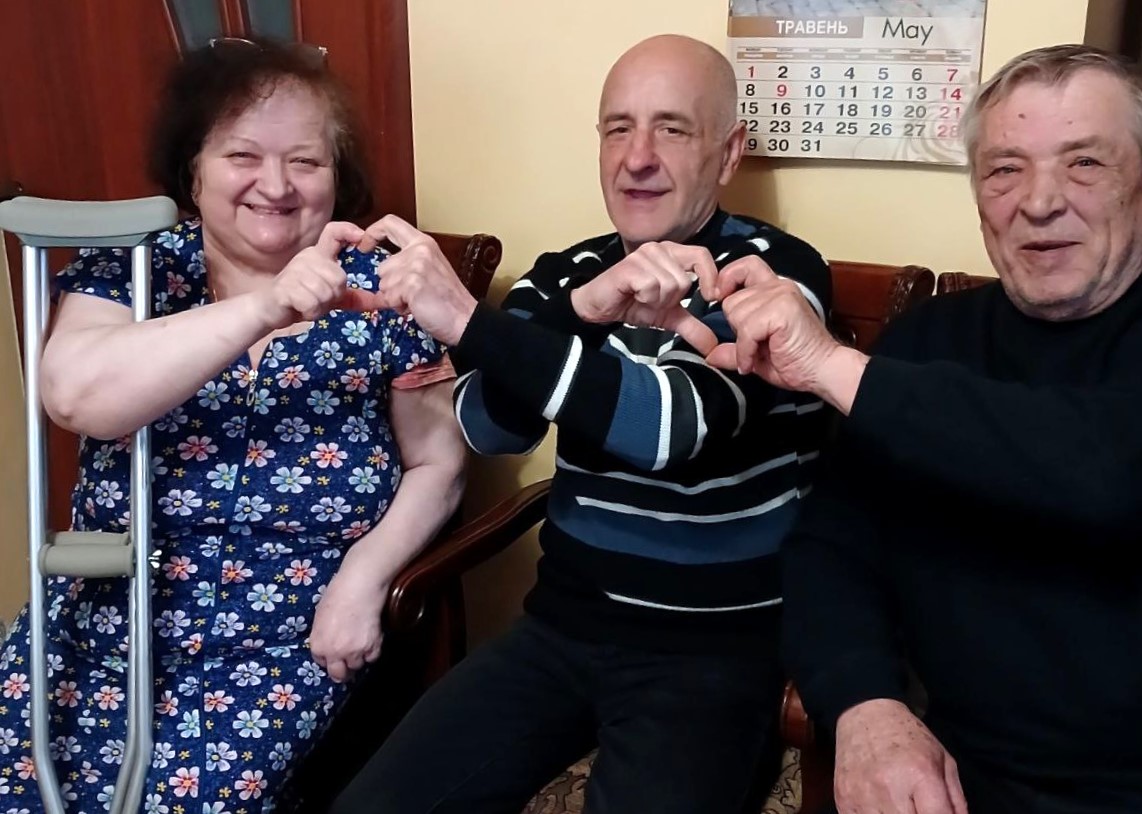 Olena, 69, with her husband Yurii, 71, and their neighbour Pavlo